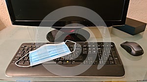 Surgical face protection mask on a computer keyboard