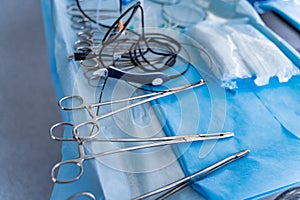 Surgical instruments arranged on a sterile field. Tools in the operating room. Closeup.