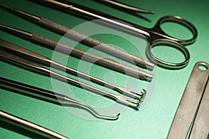 Surgical instruments on green hospital drape