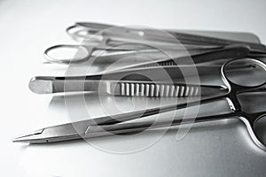 Surgical instruments on metal tray. Scalpel, clamp, scissors, surgical forceps on white background. Medical instruments