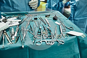 Surgical instruments in the operating room, the surgeon`s assistant arranges them on a sterile takani. The concept of