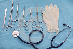 Surgical instruments and tools including scalpels, forceps and tweezers arranged on a table for a surgery