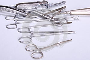 surgical instruments and tools including scalpels, forceps tweezers arranged on a table for surgery