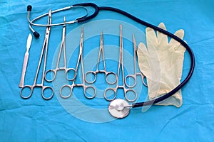 Surgical instruments and tools including scalpels, forceps and tweezers arranged on a table for a surgery