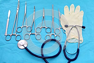 Surgical instruments and tools including scalpels, forceps and tweezers arranged on a table for a surgery