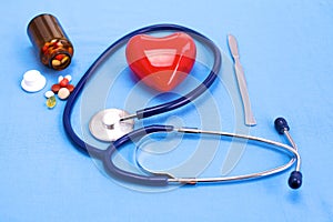 Surgical instruments and tools including scalpels, forceps and tweezers arranged on a table for a surgery