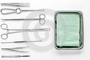 Surgical instruments and tools including scalpels, forceps and tweezers on white table top view mock upmock up