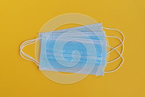 Surgical mask 3 ply on yellow background