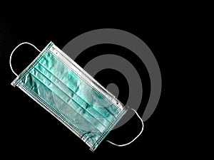 Surgical mask on black background