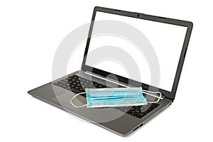 Surgical mask on a laptop computer