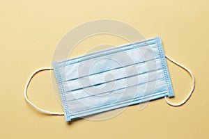 Surgical mask with rubber ear straps. Typical 3-ply surgical mask to cover the mouth and nose. Procedure mask from bacteria.