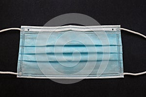 Surgical mask with rubber ear straps. Typical 3-ply surgical mask, masks pff2 and pff3 against covid. Procedure mask from bacteria photo