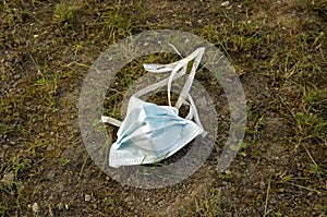 Surgical mask thrown in dirt