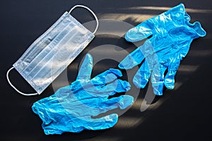 Surgical Masks, Face Mask Disposable and medical gloves on a black background