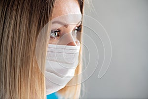 Surgical Nurse or doctor with face mask. Close up portrait of young caucasian woman model
