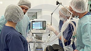 Surgical nurse points her finger on the monitor