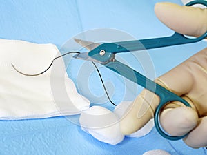 Surgical scissors cutting suture thread