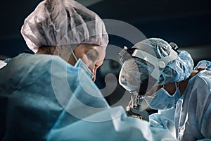 Surgical team in the operating room, close-up. An international team of professional doctors in a modern operating room