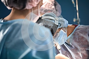 Surgical team in the operating room, close-up. An international team of professional doctors in a modern operating room