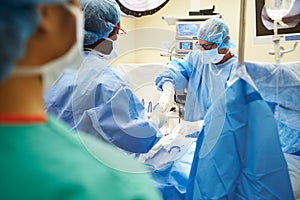 Surgical Team Working In Operating Theatre