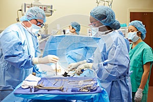 Surgical Team Working In Operating Theatre