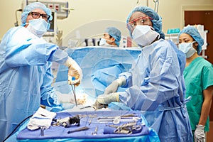 Surgical Team Working In Operating Theatre