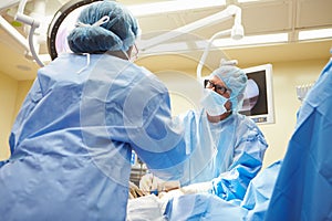 Surgical Team Working In Operating Theatre