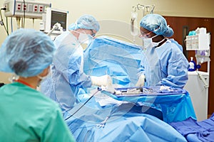 Surgical Team Working In Operating Theatre