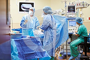 Surgical Team Working In Operating Theatre