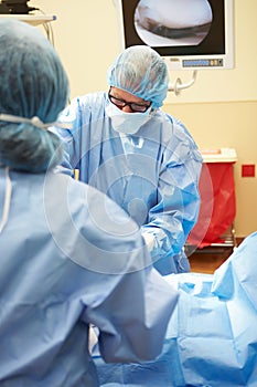 Surgical Team Working In Operating Theatre