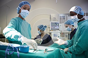 Surgical Team Working On Patient In Hospital Operating Theatre