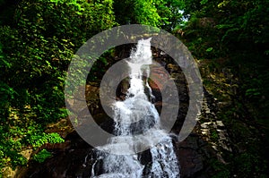 The surging waterfall flow from end of  cliff