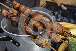 Suri - an Amazonian grub that feeds on palm sap, grilled and served as a snack food in Iquitos, Peru