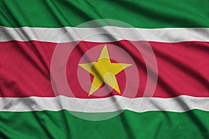 Suriname flag is depicted on a sports cloth fabric with many folds. Sport team banner photo