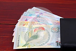 Surinamese guilder in the black wallet photo