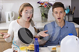 Surpised siblings at breakfast table