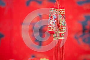 The surplus pendant in front of the red spring couplets background