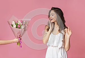 Surprise Bouquet Concept. Happy Woman Getting Bunch Of Tulips As Gift