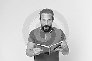 Surprise concept. Bearded man shocked with surprise. Senior man reading book with surprise. Real surprise