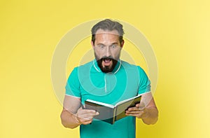 Surprise concept. Bearded man shocked with surprise. Senior man reading book with surprise. Real surprise