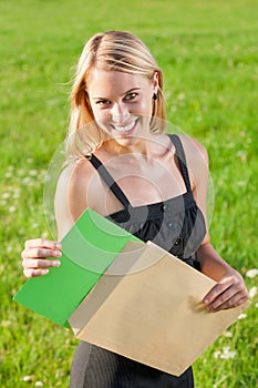 Surprise envelope young businesswoman sunny meadow
