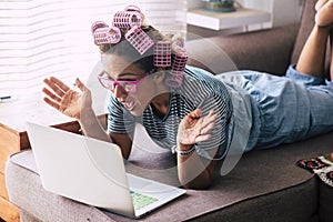 Surprise and excited happy woman at home looking laptop computer sitting on the sofa - beauty hair care fre female people -