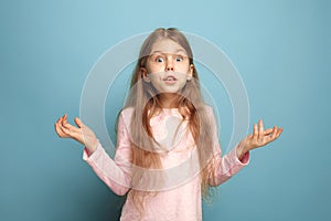 The surprise, happiness, joy, victory, success and luck. Teen girl on a blue background. Facial expressions and people