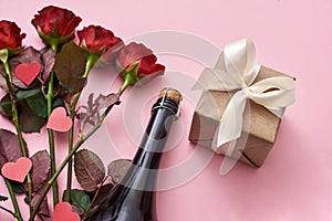 Surprise for her. Special gift box with white ribbon, red roses and champagne