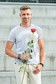 Surprise for his love. Life is too short to live without love. Handsome guy with rose flower romantic date. Man in love