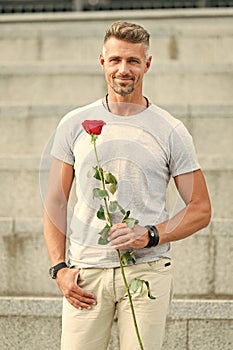 Surprise for his love. Life is too short to live without love. Handsome guy with rose flower romantic date. Man in love