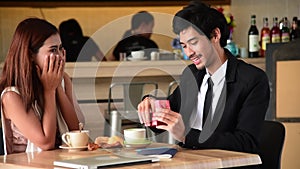 Surprise proposal at coffee shop young couple lover ask girlfriend to will you marry me and she said I do on valentine`s day smile