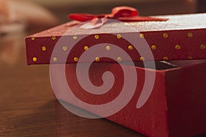 Surprise red gift box with bow on cap