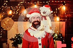 Surprise. santa claus hold teddy bear. merry christmas. man santa hat. winter holidays. wait for xmas presents. happy