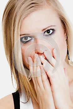 Surprised afraid girl covering mouth with hand